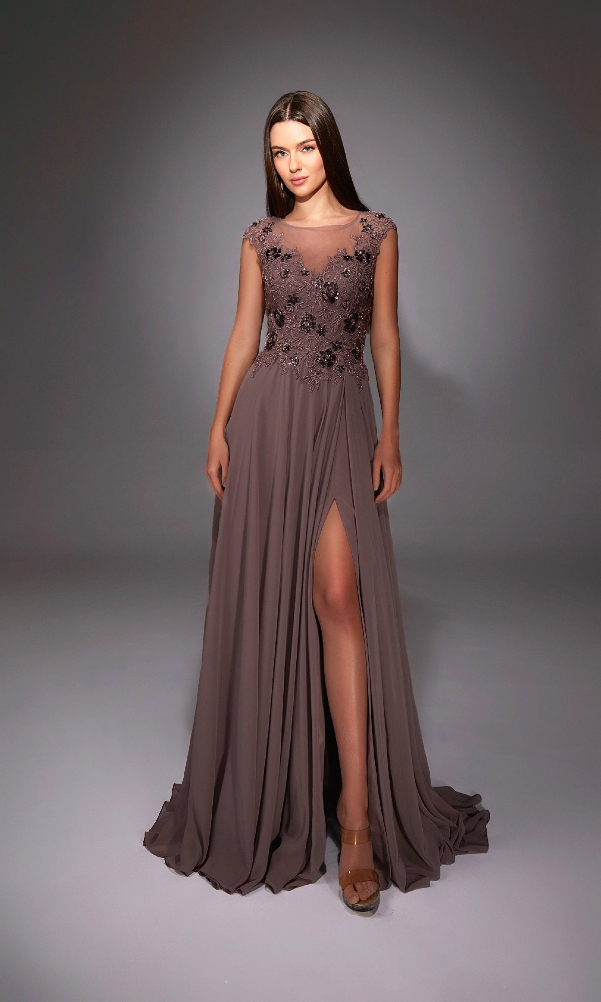 A woman wearing the Long Formal Dress: Alyce 27842, a sleeveless mauve evening gown with floral bodice embellishments and a thigh-high slit, stands against a neutral background.